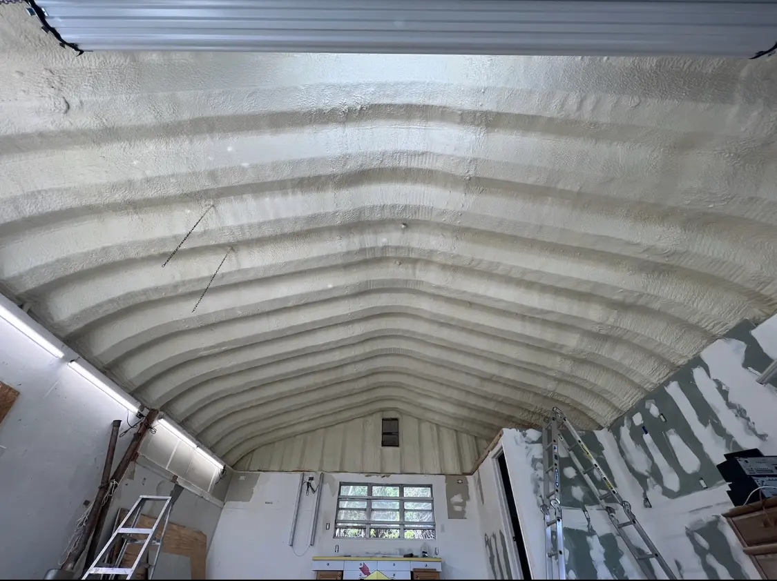Spray polyurethane foam applied to the underside of a metal roof deck in Rowley